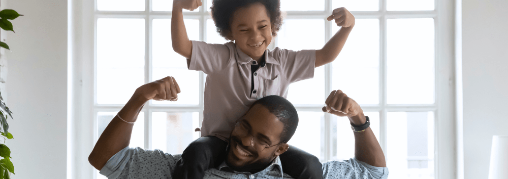 Adjusting the Lens: 3 Simple Steps to a More Neurodiversity Affirming Practice - A man is has a young boy on his shoulders and his arms are raised in strength
